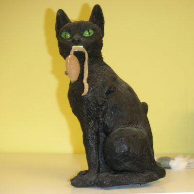 Damien is a very special black male cat with glowing green eyes.